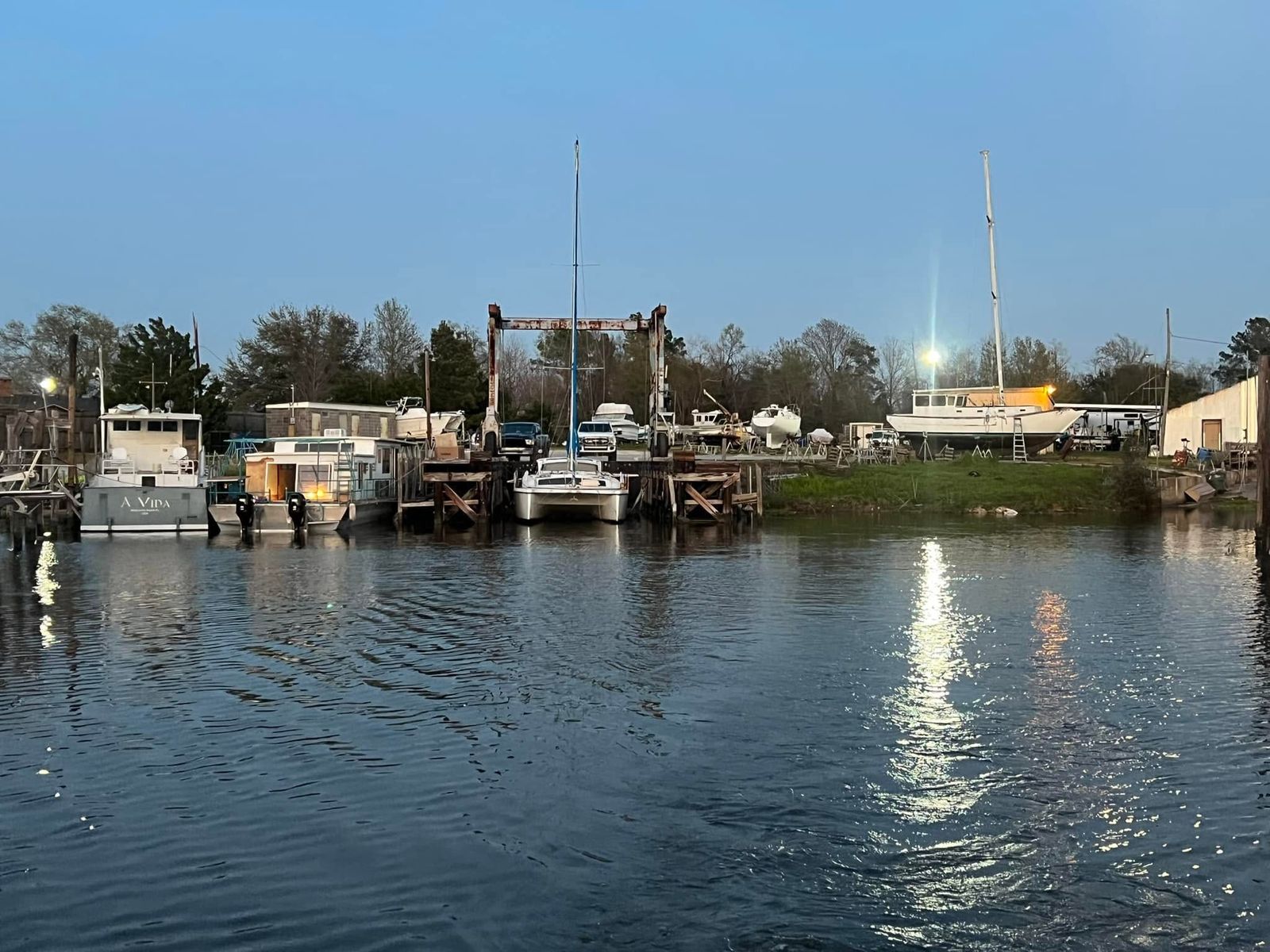 The waterfront facility on Sabine Lake showing multiple boats, docks, service equipment and operational infrastructure.