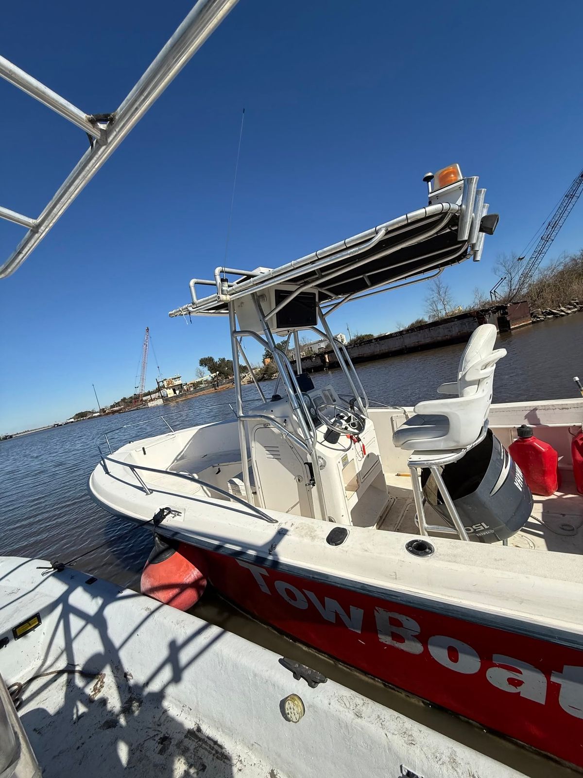 A TowBoatUS service vessel with towing equipment moored at the dock on Sabine Lake.